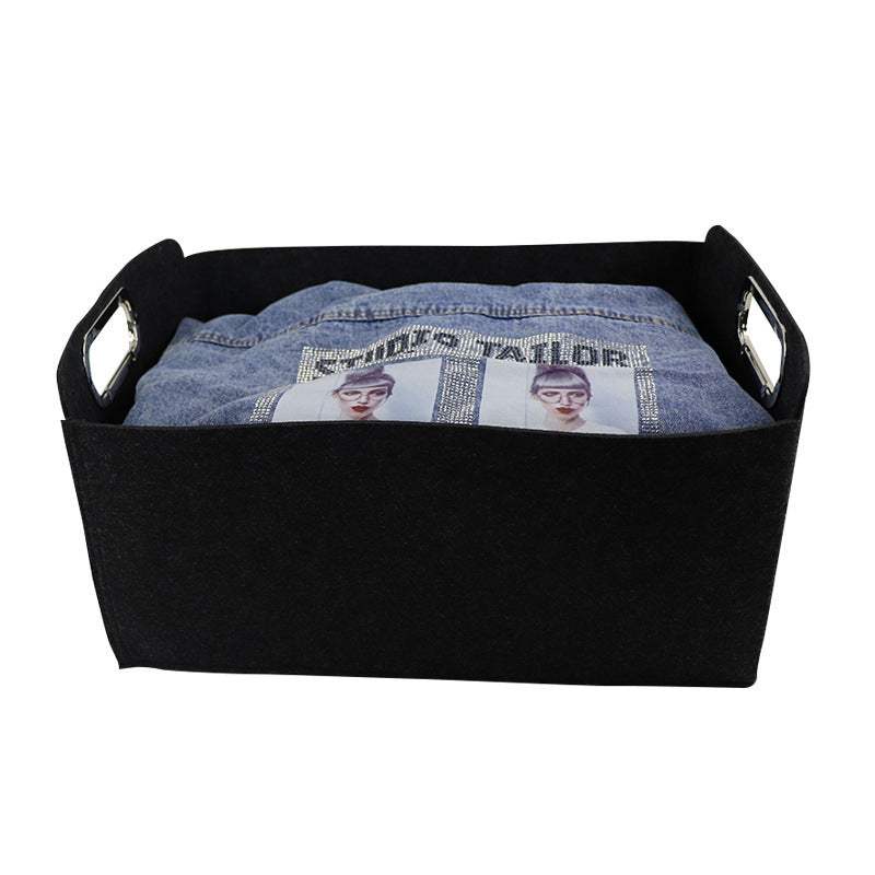 Nordic felt storage basket with handles holding blue fabric.