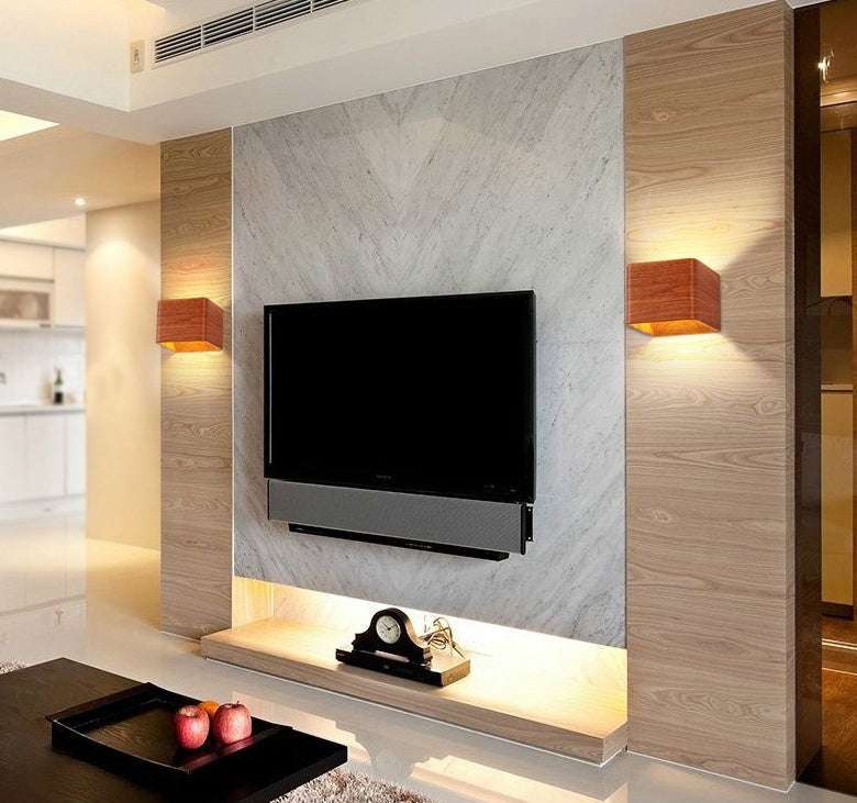 Square LED indoor lighting wall lamps in a modern living room setting.