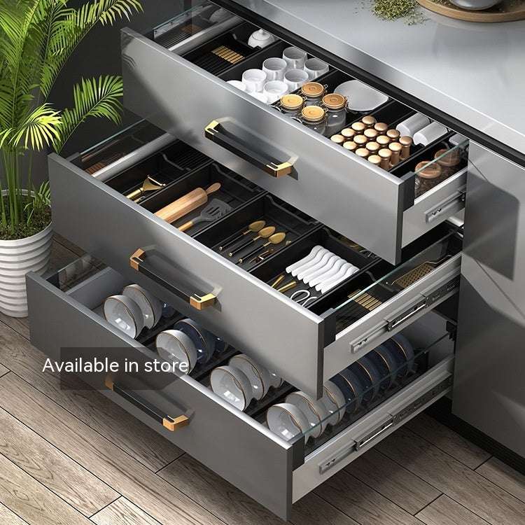 Kitchen drawer storage with aluminum partitions and multi-purpose organization.