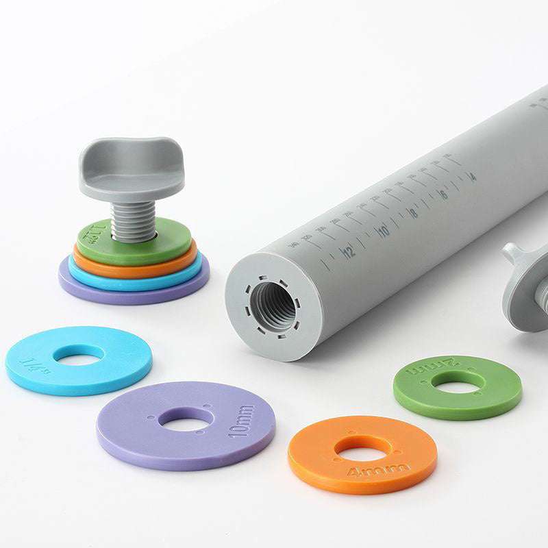 Adjustable thickness rolling pin with colored silicone rings for versatile baking.