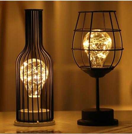 Minimalist hollow table lamps with iron frame and warm LED lighting.