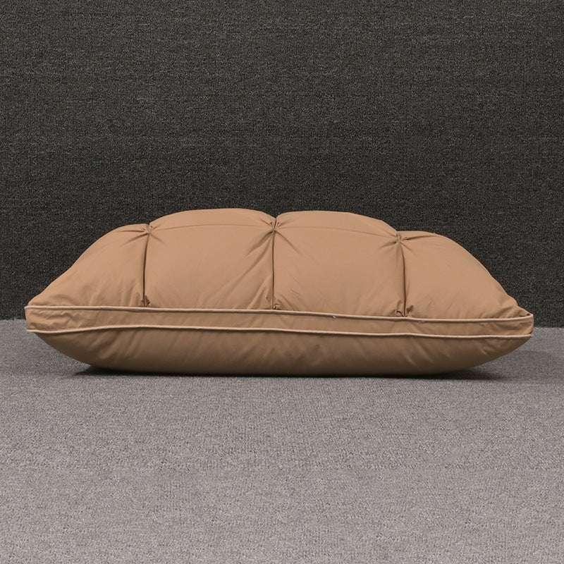 Rectangular brown pillow on gray surface.