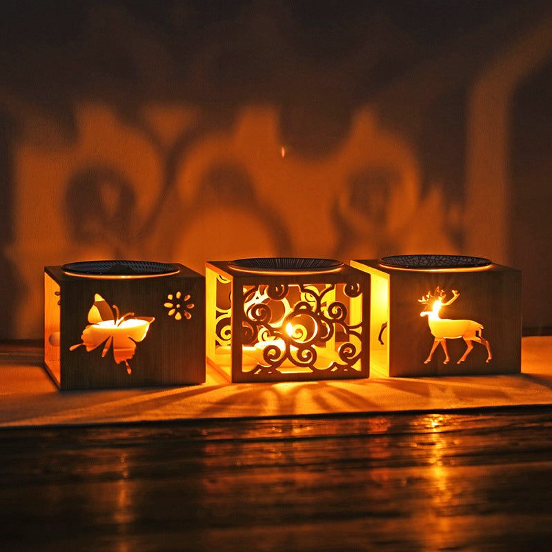 Bamboo candle lamp with butterfly, swirl, and deer designs glowing in warm light for aromatherapy.