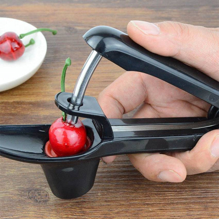 Cherry Red Date cherry pit remover tool in use, black and green ABS material.