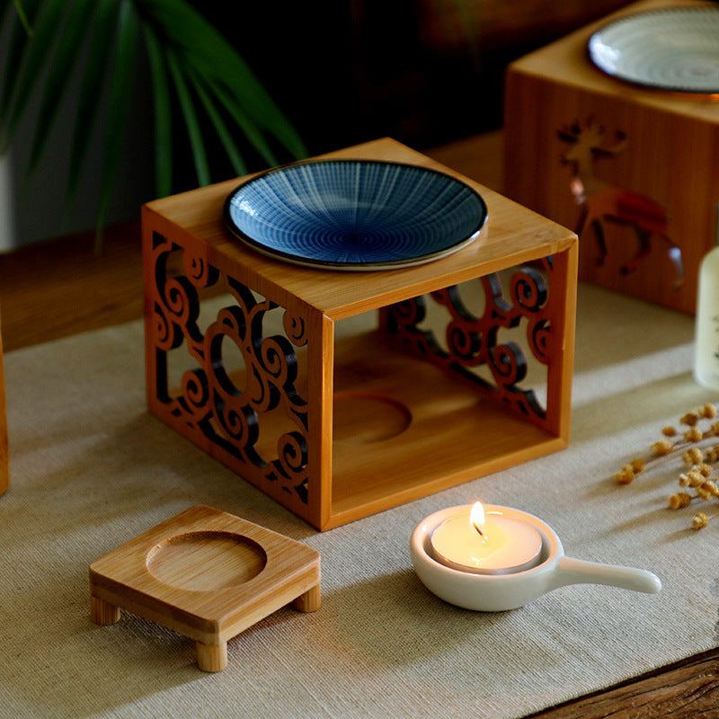 Bamboo candle lamp with ceramic oil dish for aromatherapy on a wooden base, suitable for essential oils and decoration.
