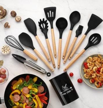 Silicone kitchenware set with wooden handles displayed on a countertop.
