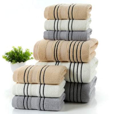 Stacked pure cotton towels in khaki, white, and gray with striped design, showcasing the household bath set.