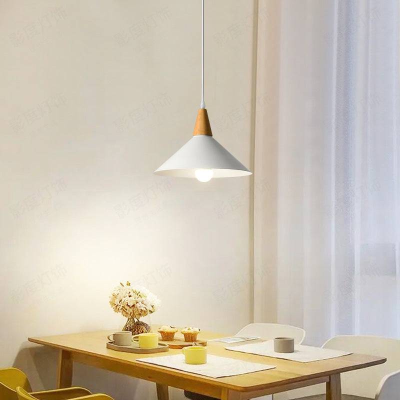 Japanese minimalist wooden chandelier with LED light illuminating a tea room table.