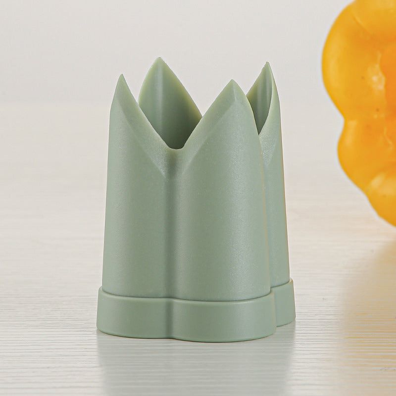 Green core remover tool on a kitchen countertop, made of ABS material, modern simplicity style.
