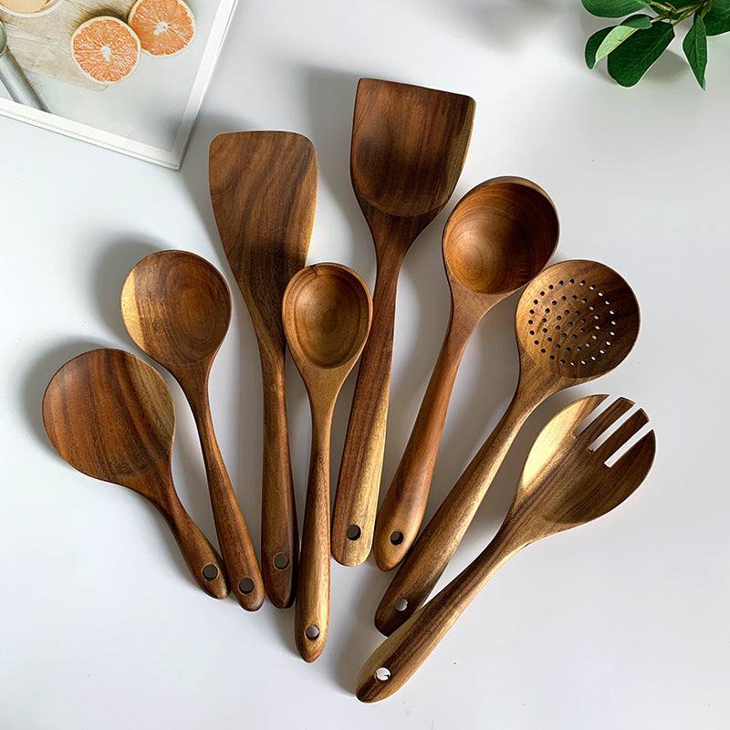 Thailand teak natural wood kitchen tool set on white background, featuring spoons, ladles, and skimmers with long handles.