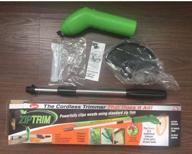 Cordless lawn trimmer with accessories and packaging.
