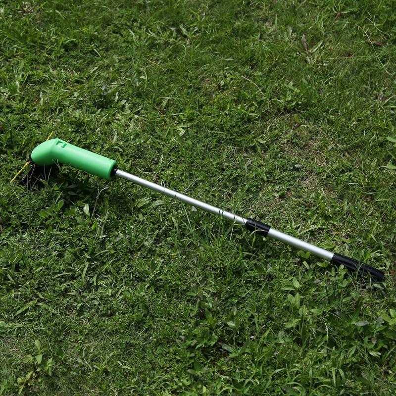 Cordless lawn trimmer in grass with lightweight extension pole.