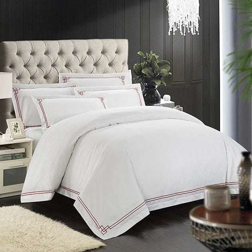 Four-piece cotton bedding set with pure cotton fabric, twill weave, and plain pattern displayed on a bed.