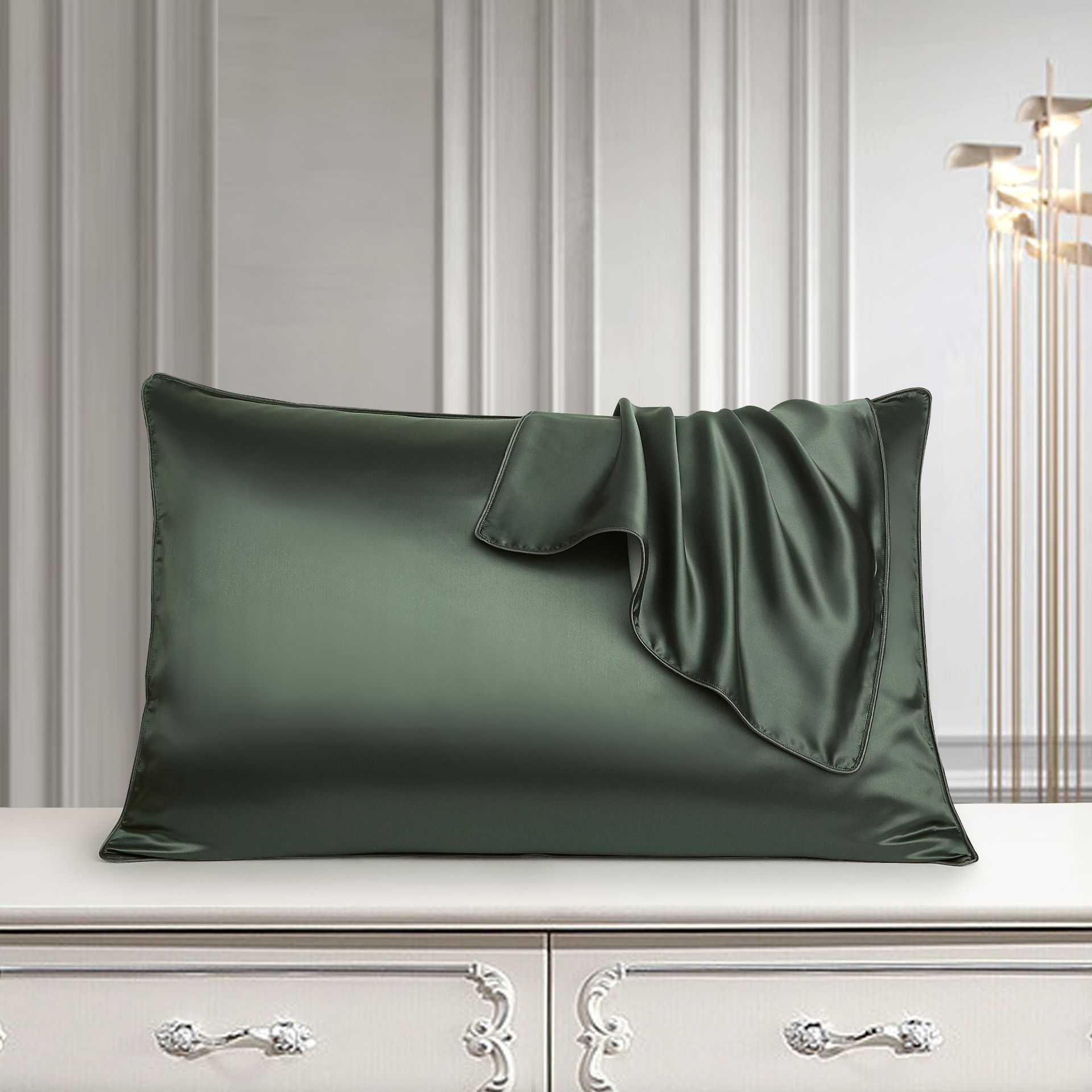Luxurious green silk pillowcase on elegant dresser setting.