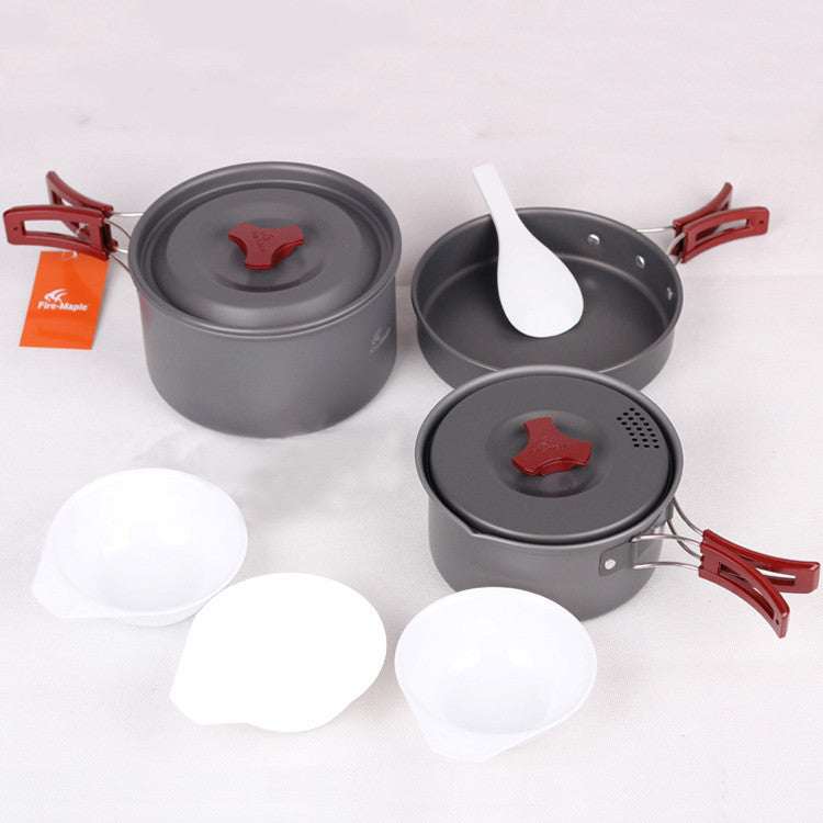 Picnic cookware set with hard alumina pots and frying pan, including spoons and bowls.