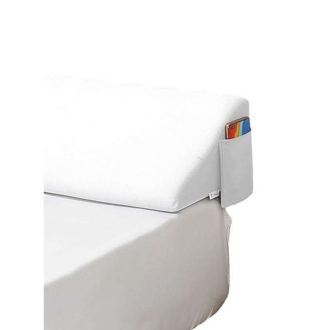 Long white wedge pillow filling gap between bed and bedside in modern simplicity style.