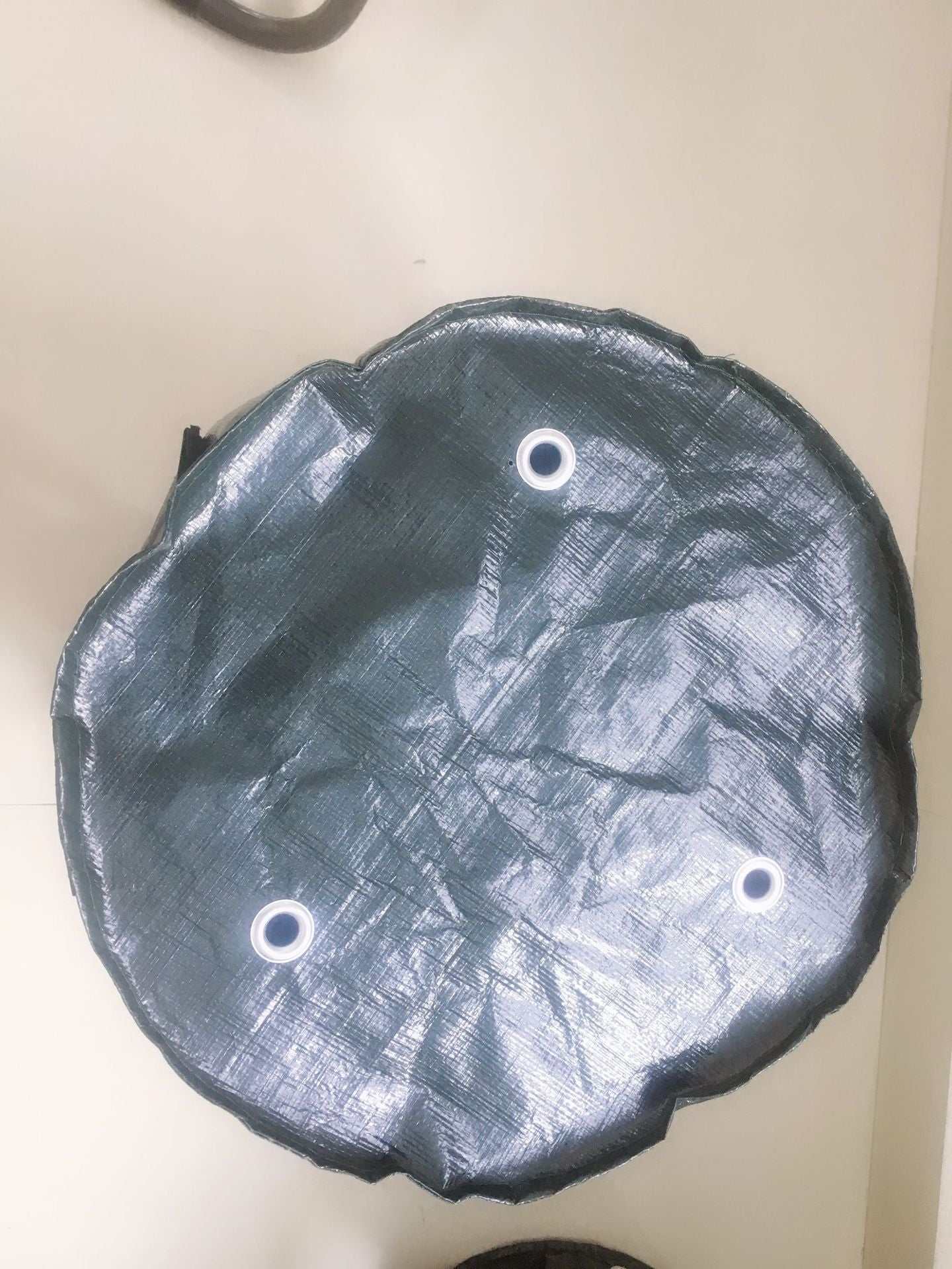 Dark green PE cloth garden planting bag with drainage holes.