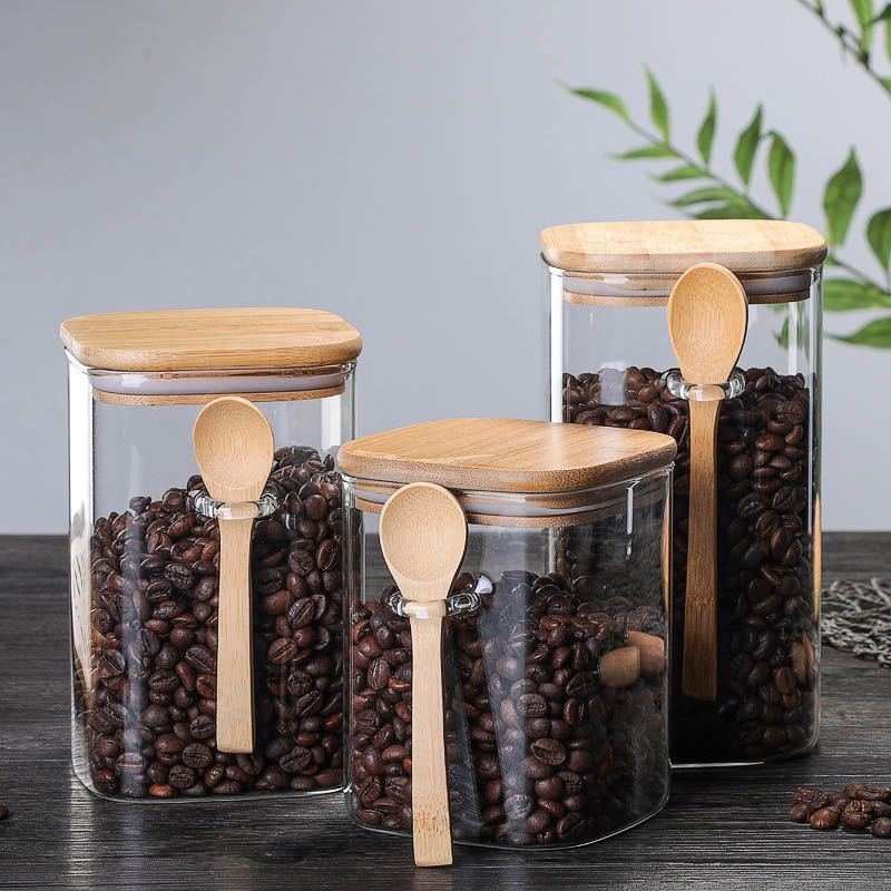 Japanese-style glass kitchen food storage cans with wooden lids and spoons, square shape, microwave-safe, 800-1000ml capacity.