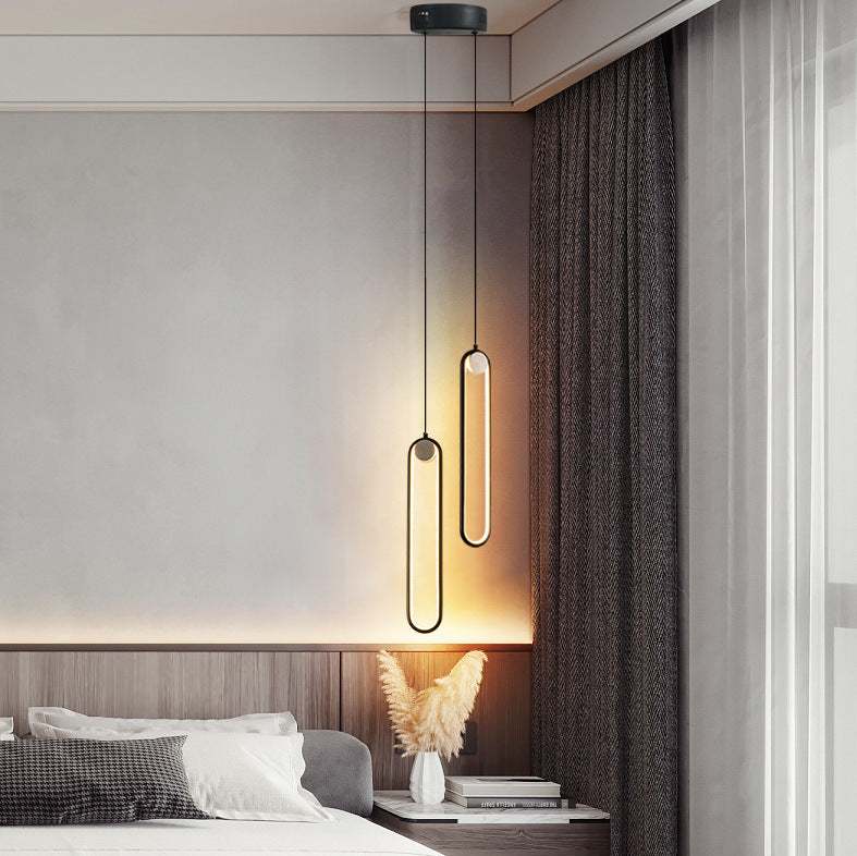 Nordic Minimalist Oval Bedside Chandelier in modern bedroom setting.