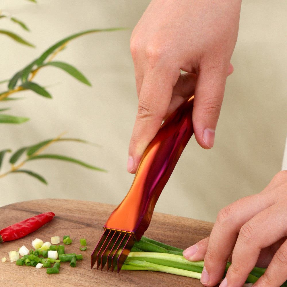 Metallic kitchen onion knife used for slicing green onions.