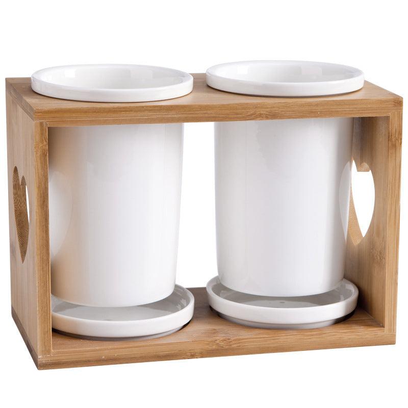 Nordic household ceramic chopstick holder with bamboo wooden frame and double white ceramic cylinders.