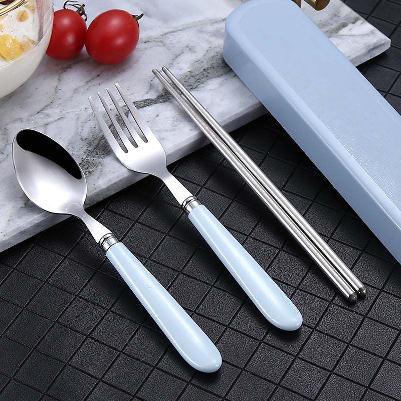 Portable Nordic tableware set with stainless steel fork, spoon, and chopsticks on a marble surface.