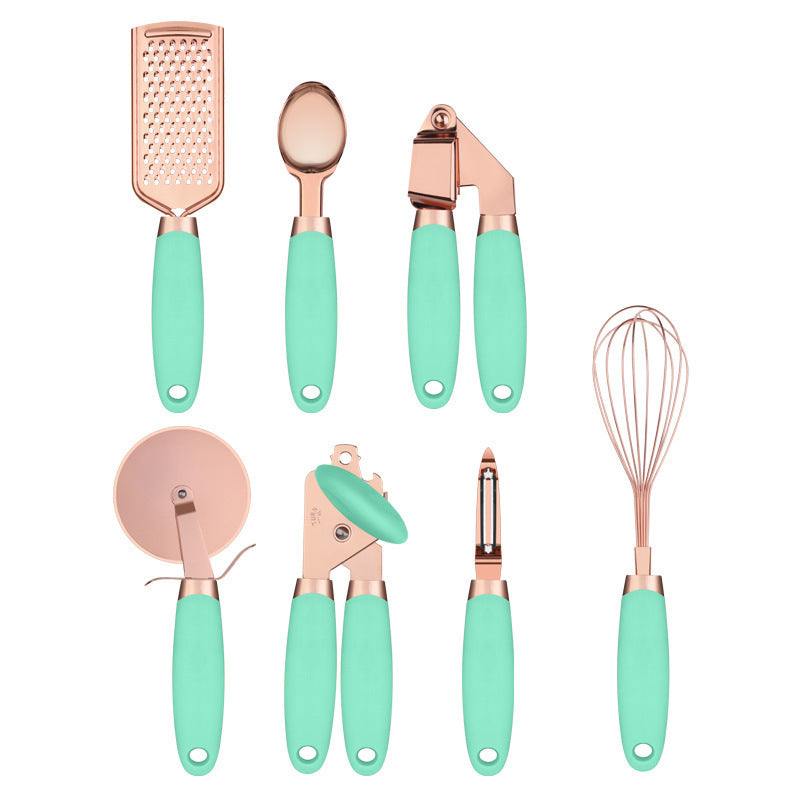 Copper-plated kitchen tool set with peeler and green handles.