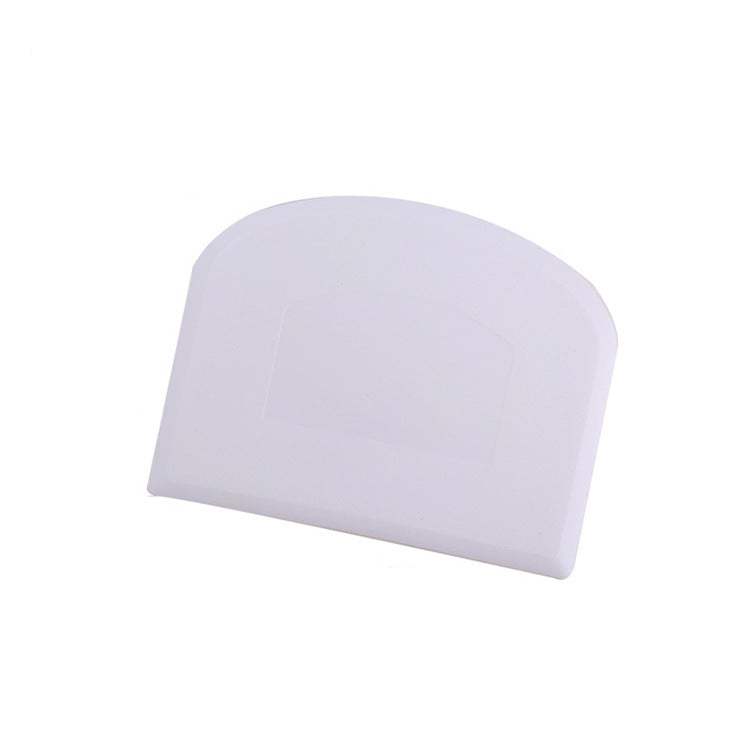 White plastic kitchen flour cutting scraper for cake and cream smoothing.