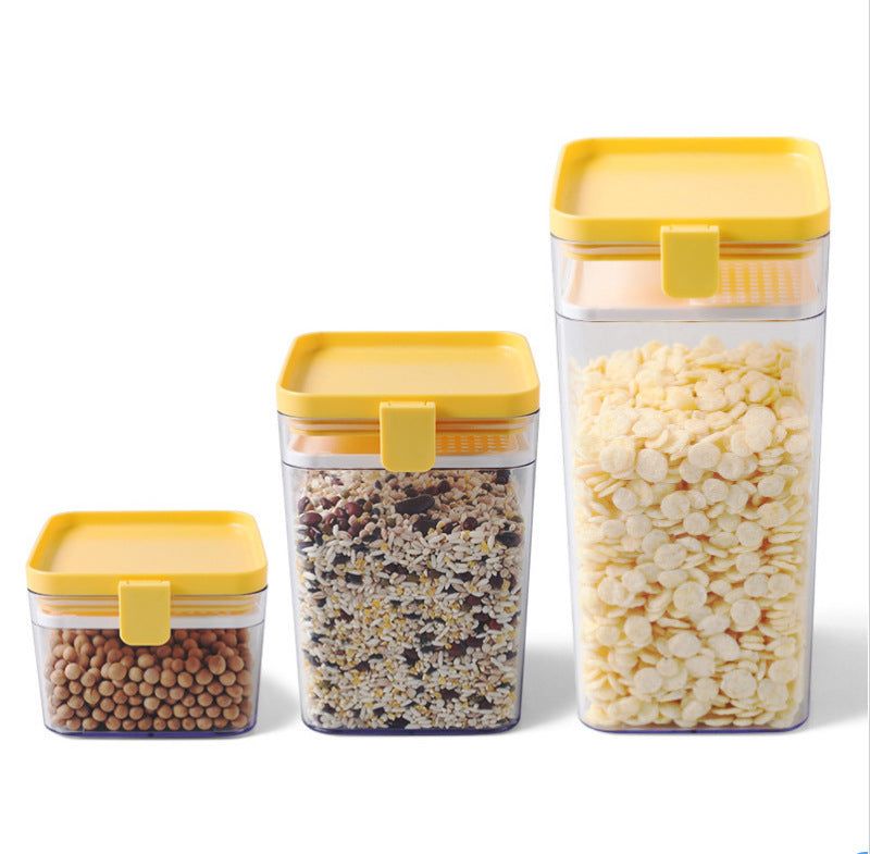 Household kitchen sealed jars with yellow lids for food storage.