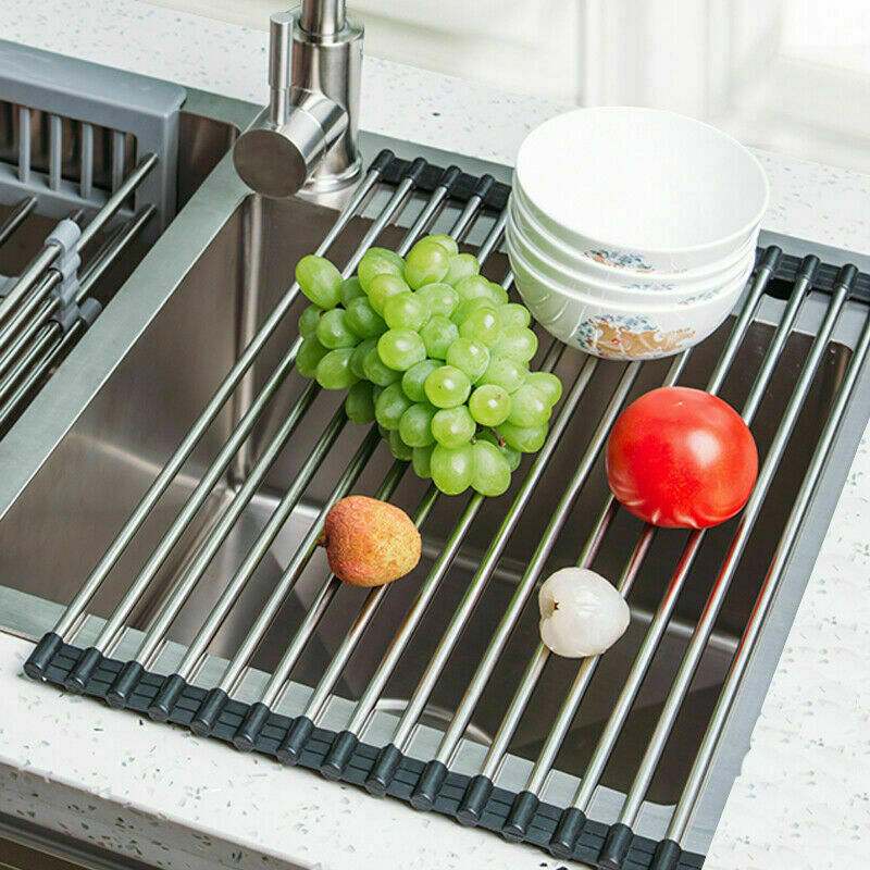 Kitchen stainless steel sink drain rack with fruits and bowls, roll-up design for efficient drying.