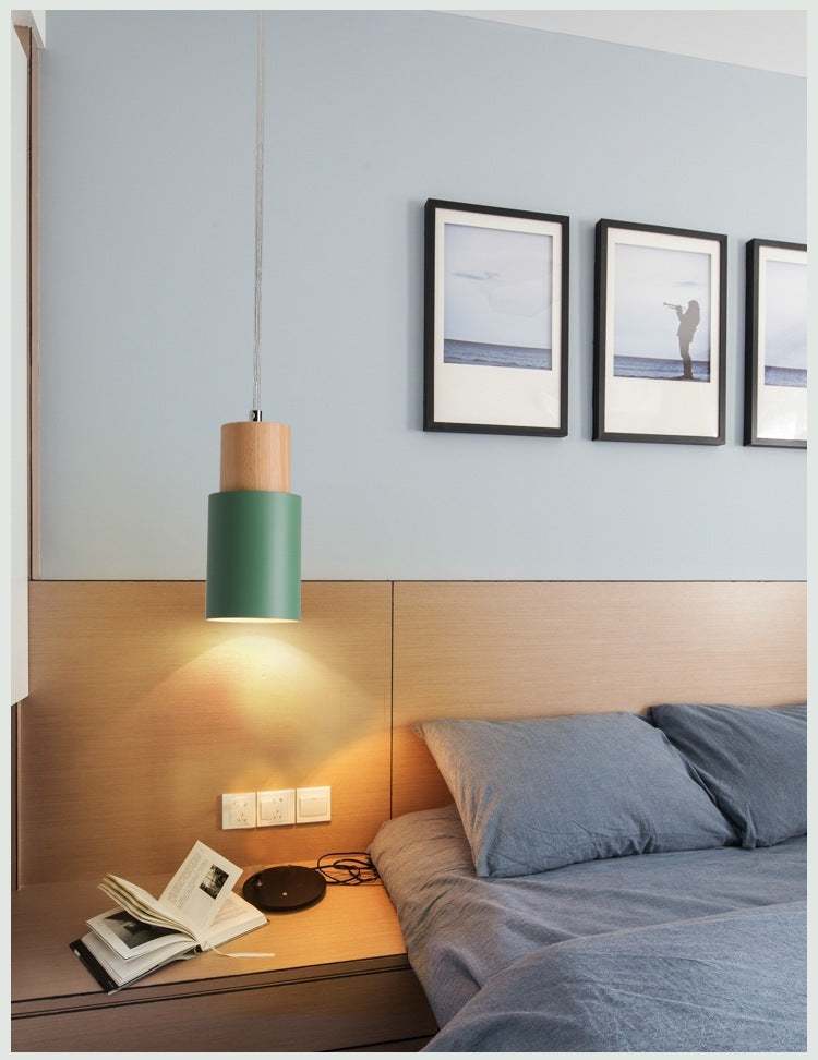 Modern Macaron bedside chandelier in bedroom setting with adjustable height.