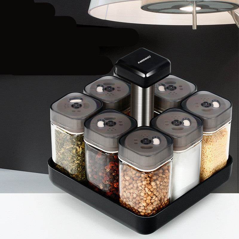 Spice jar glass organizer with black lids and stand, Southeast Asian style for kitchen use.