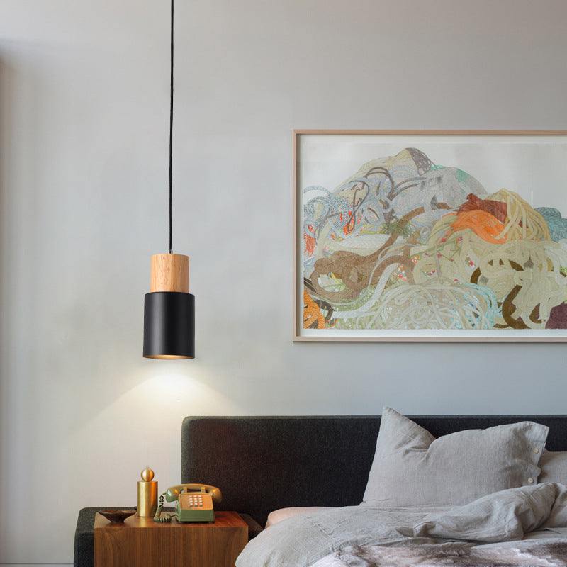 Modern Macaron bedside chandelier in a cozy bedroom setting.