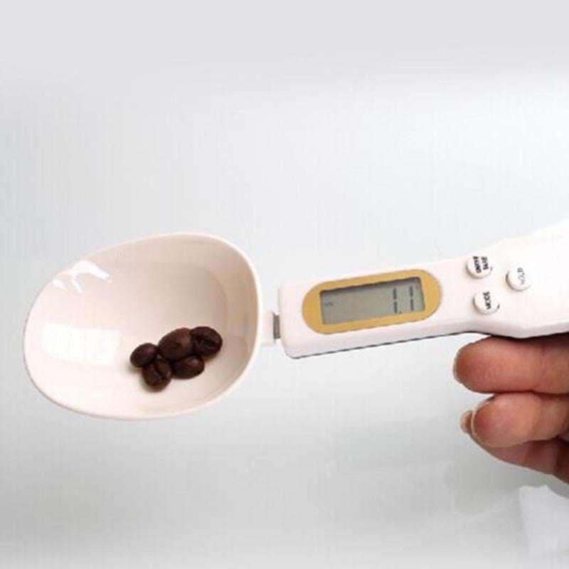 LCD digital kitchen scale with spoon, measuring coffee beans accurately, white ABS plastic material.
