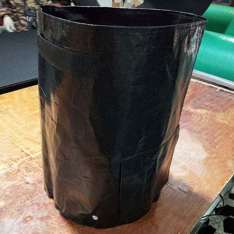 Dark green PE cloth garden planting bag with handles and drainage holes, ideal for outdoor gardening and easy harvesting.