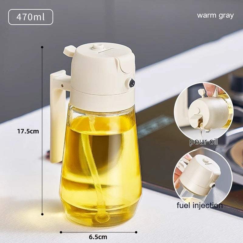 470ML olive oil sprayer dispenser with ergonomic handle and dual functionality for spraying or pouring oil on kitchen countertop.