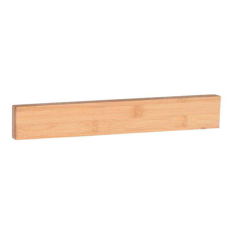 Bamboo magnet knife holder, wall-mounted for kitchen storage.