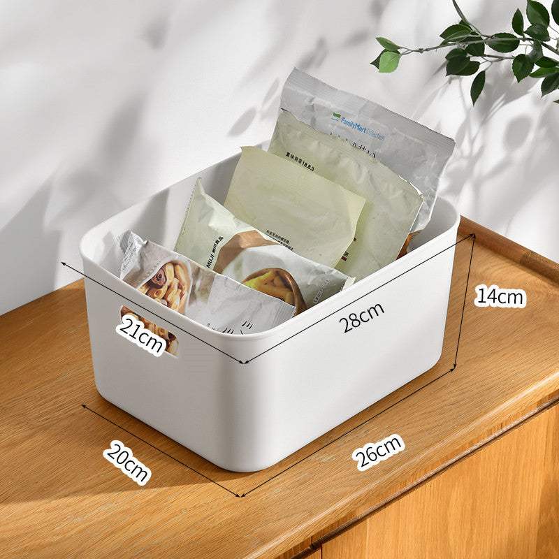 Kitchen cabinet organizer storage box on a countertop containing packaged goods.