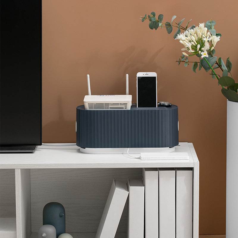 Power Strip Wire Case Cable Storage Box on a shelf with a phone and router, featuring a sleek design for organized cable management.