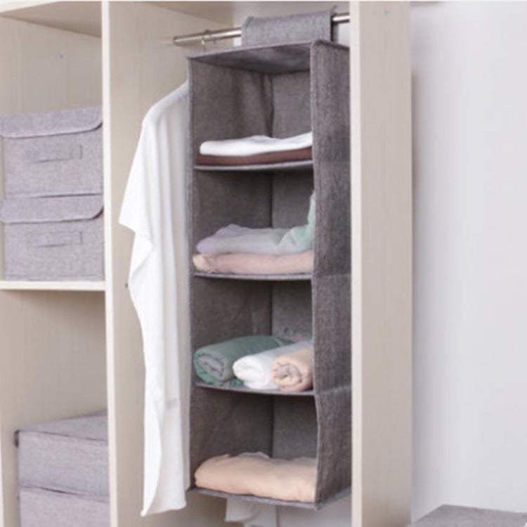 Hanging cotton cloth storage organizer in closet with multiple compartments.