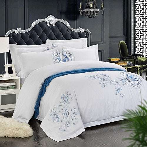 Four-piece cotton bedding set with plain twill design in elegant bedroom setting.