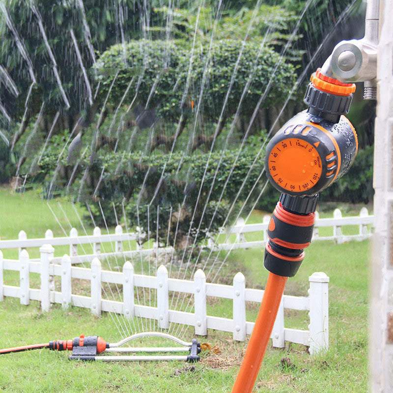 Mechanical timing controller irrigation system in garden setting.