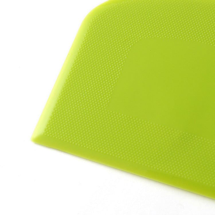 Green plastic kitchen flour cutting cake scraper.