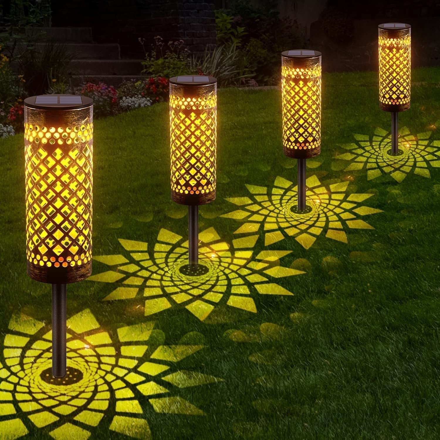 Metal solar-powered lawn lamps with warm light illuminating a garden, featuring geometric abstract art design.
