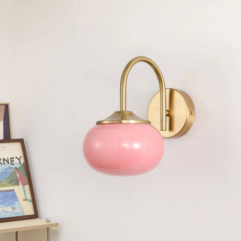 Cream style bedroom chandelier with pink glass lamp and wrought iron fixture.