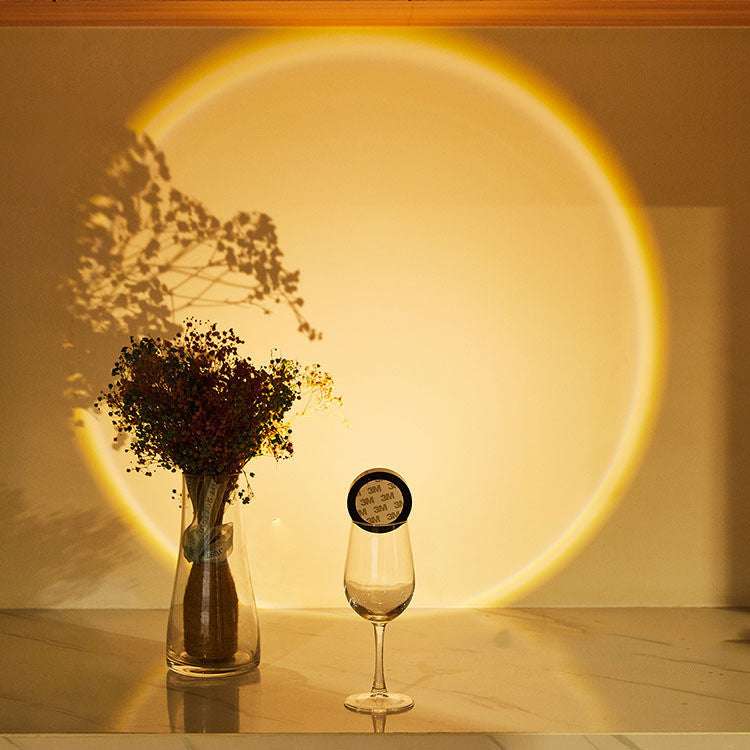 Warm sunset glow from wireless LED nightlight illuminating decor items on a shelf.