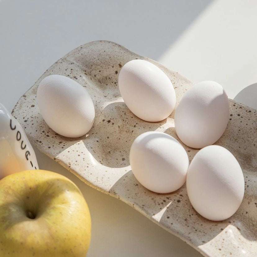 Nordic style resin egg storage box with six white eggs, suitable for kitchen or jewelry storage.