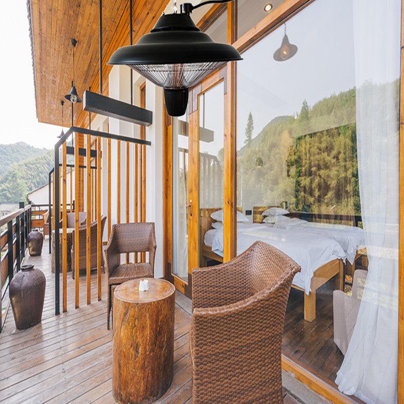 Outdoor quartz halogen tube heater on a stylish patio setting, showcasing its elegant black, silver, and copper design.