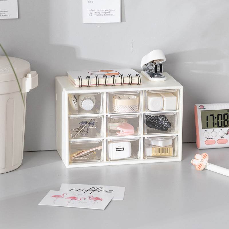 Desktop storage box with transparent drawers, holding organizer items like notebooks, tapes, and stationery.