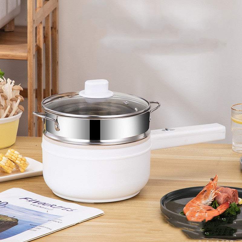 Multifunctional electric cooker with non-stick pot and glass lid on wooden table.